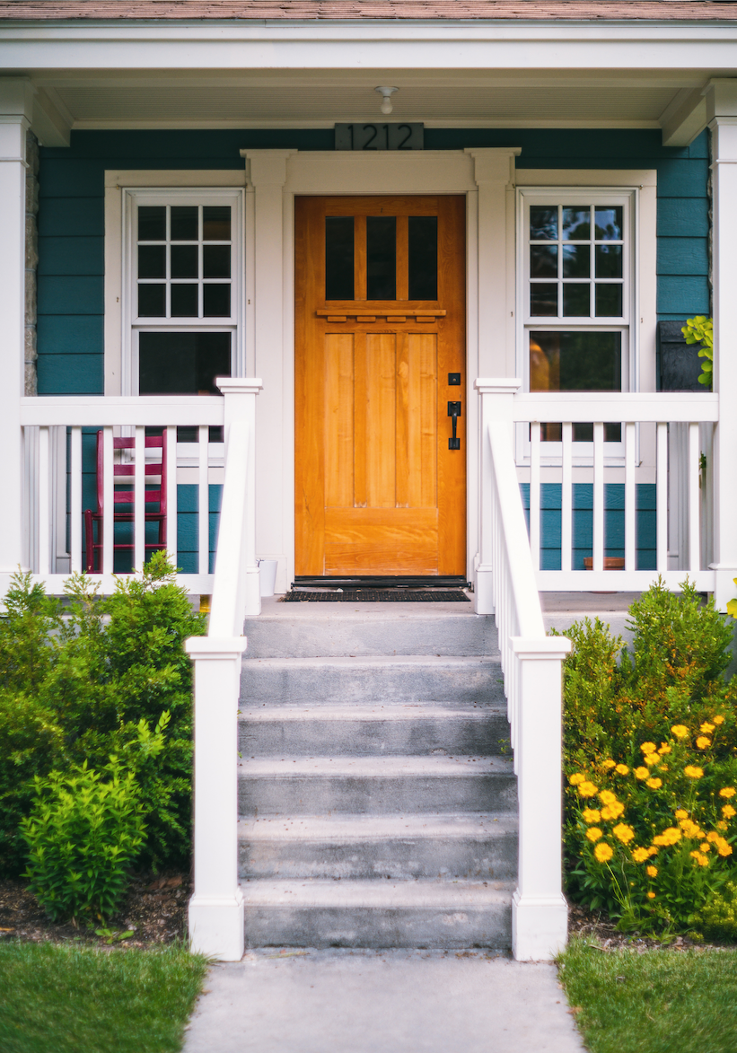 Wood front door with white railing